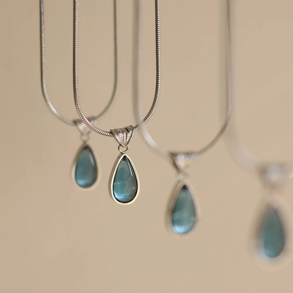 Gold-Plated Teardrop Pendant Necklace with Blue Synthetic Cat Eye Stone Crushes.